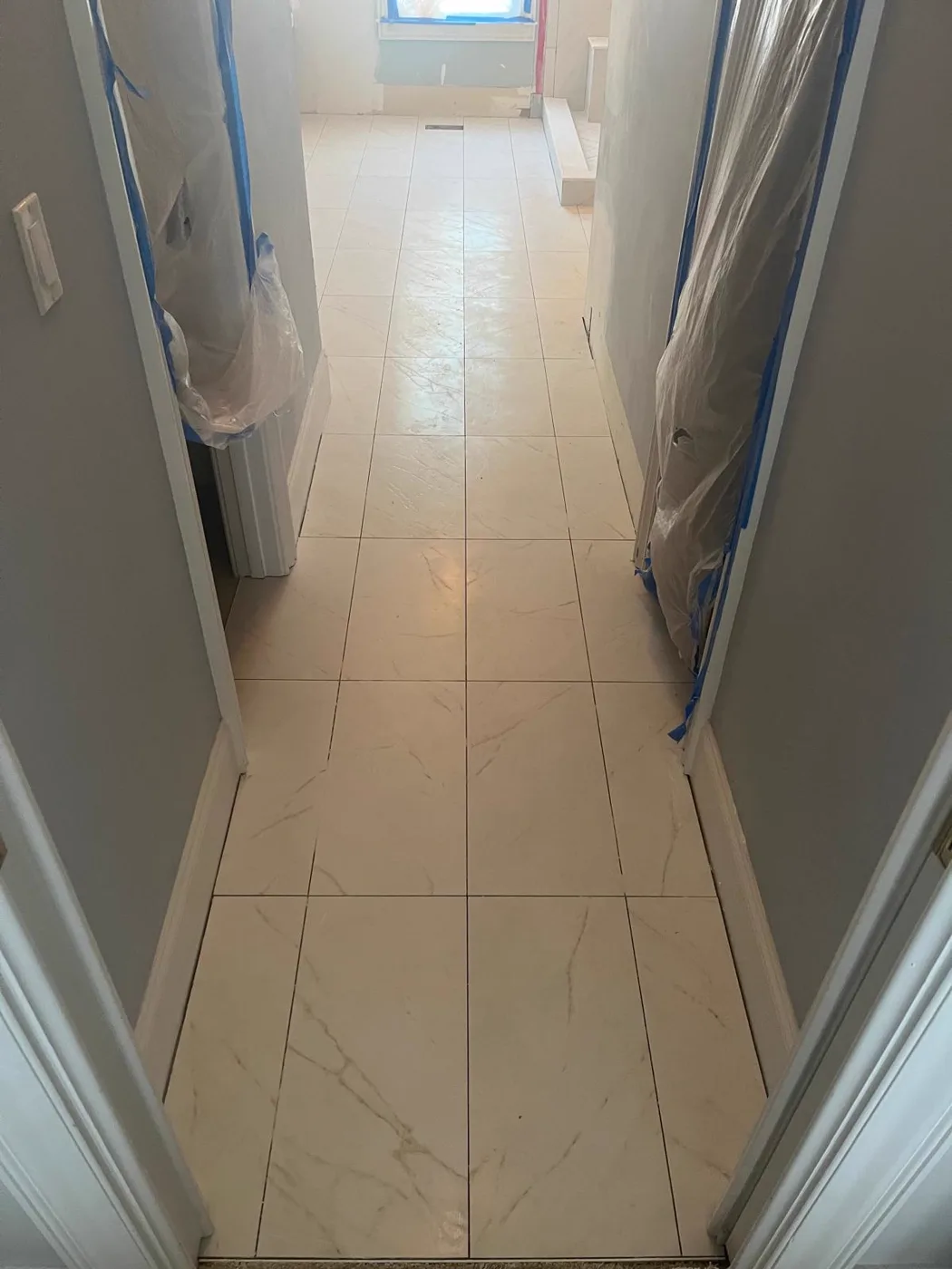 Finished marble-look tile floor in the hallway leading to the remodeled master bathroom, Metro Atlanta