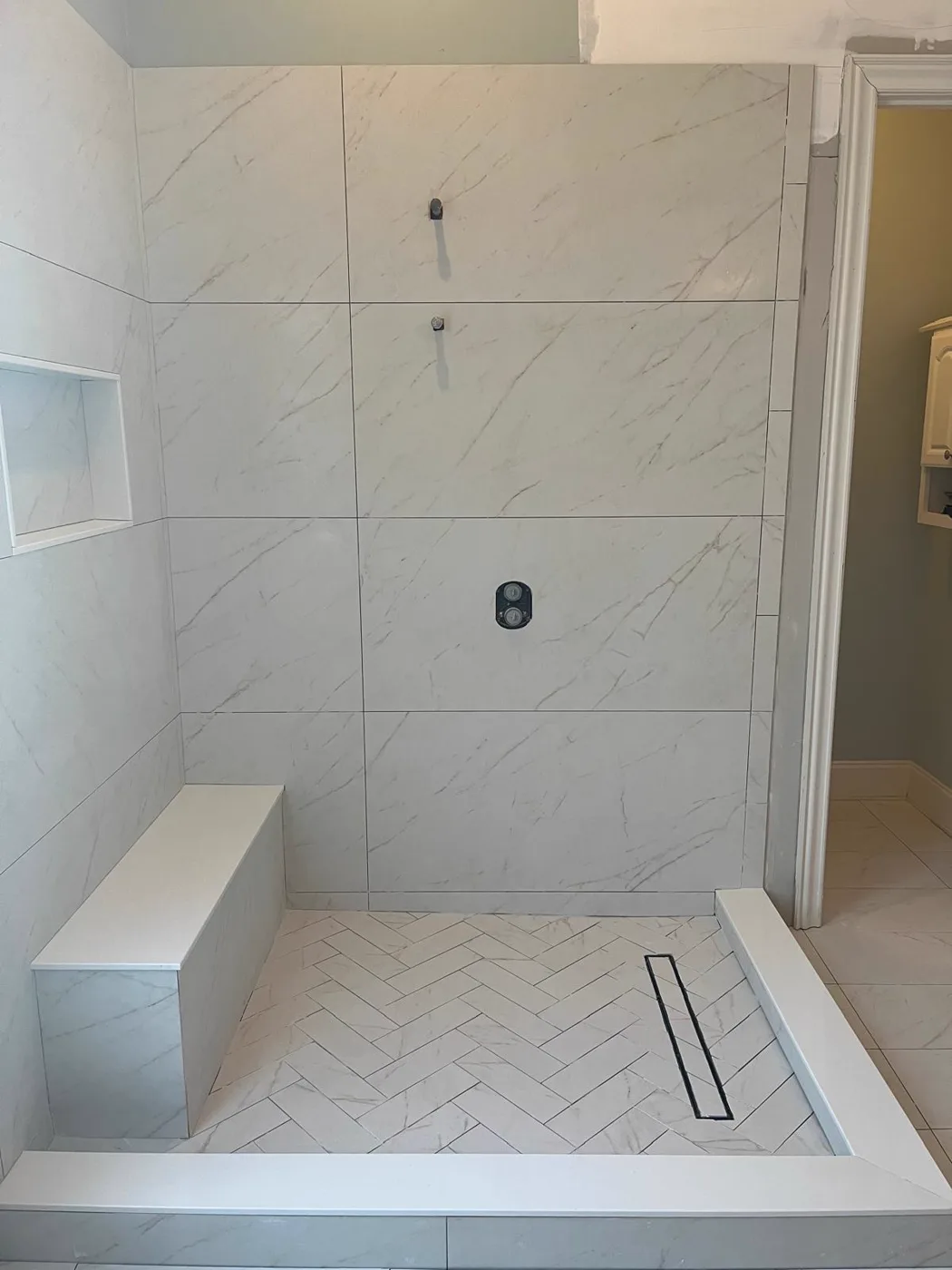 Finished walk-in shower with marble-look tile walls and a linear drain, master bathroom remodel, Metro Atlanta