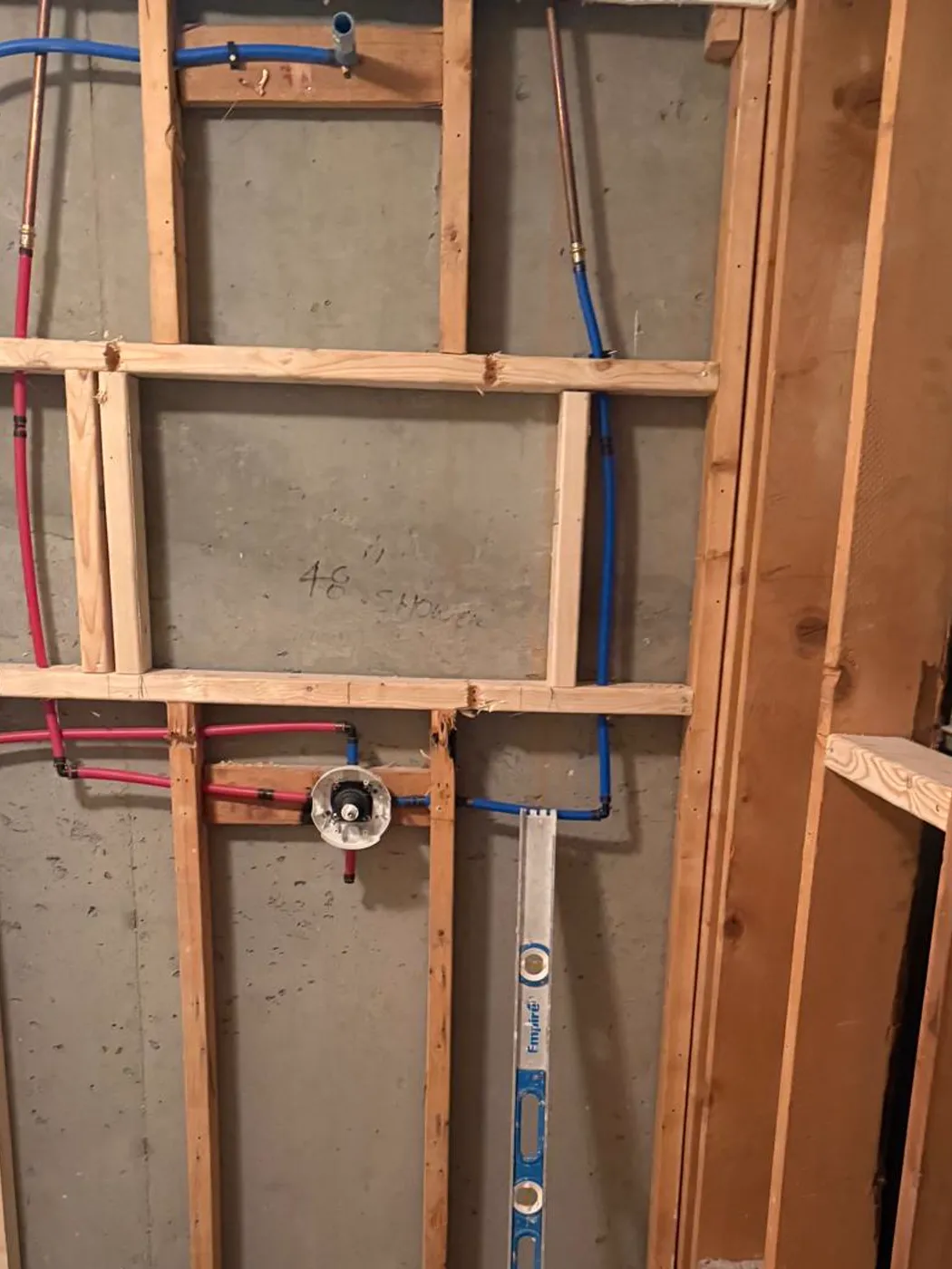 Shower plumbing rough-in with PEX supply lines and a mixing valve set in the framed wall, Metro Atlanta