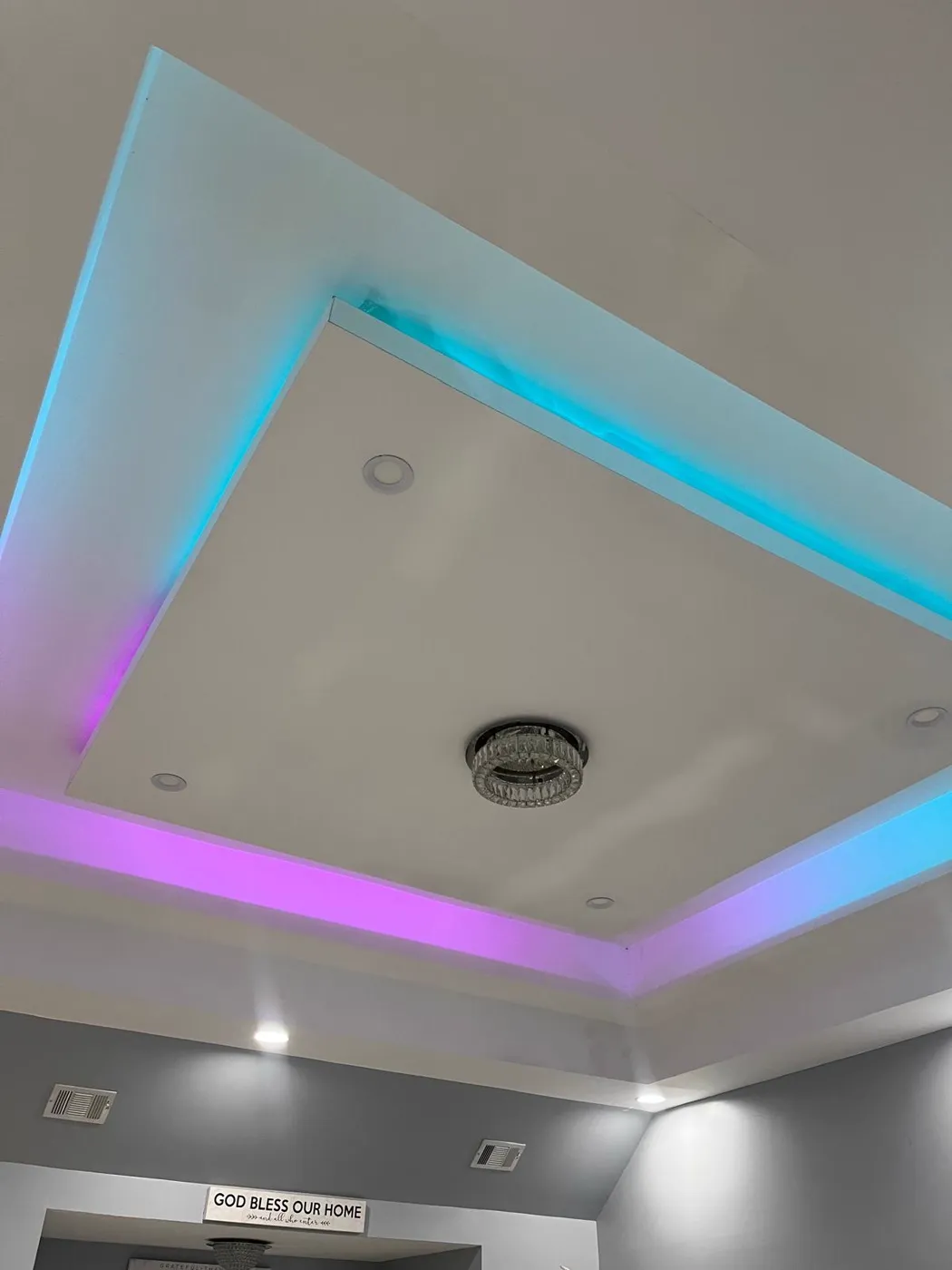 Tray ceiling with concealed colour-changing LED cove lighting and a crystal flush mount, Metro Atlanta